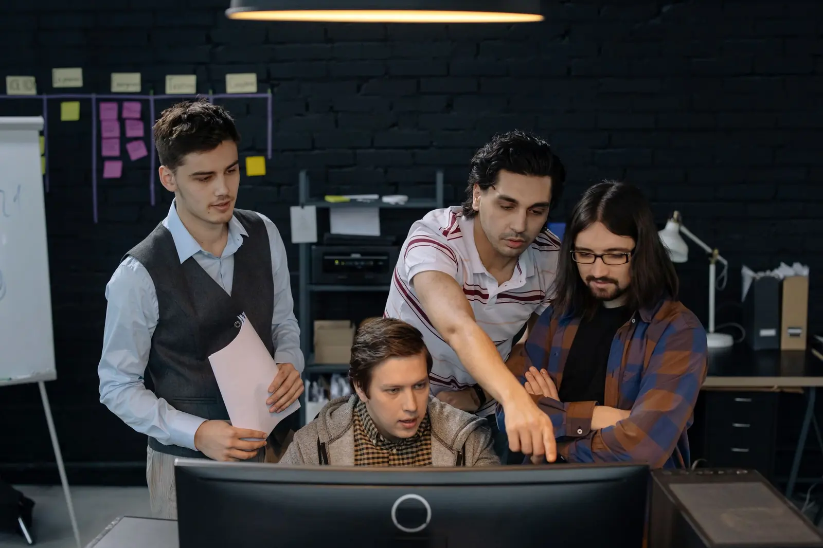 A Webist-managed team reviewing work together at one screen