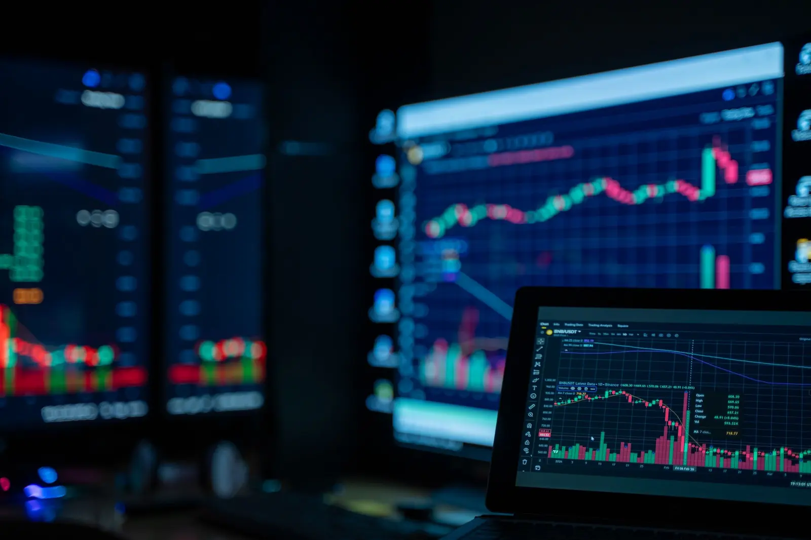 Trading screens in a dark room