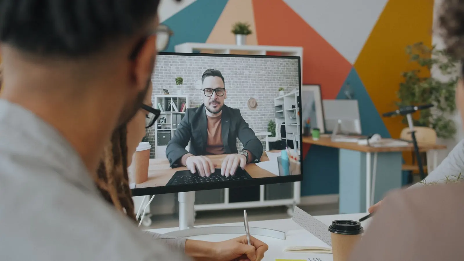 A distributed team on a video call from a modern office