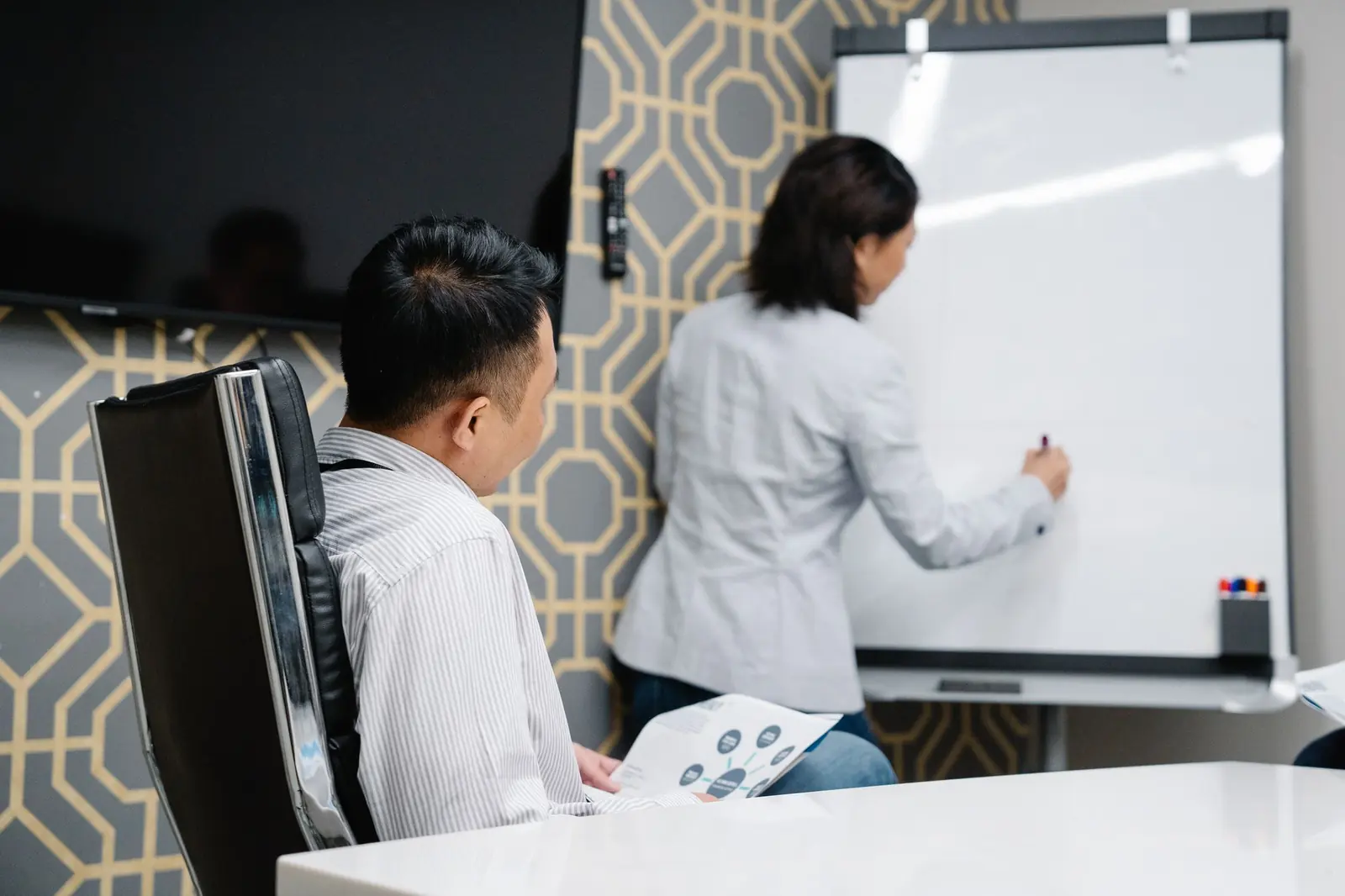 A Solution Architect mapping a roadmap on a whiteboard with the client team